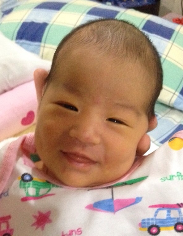 Smiling newborn light ong